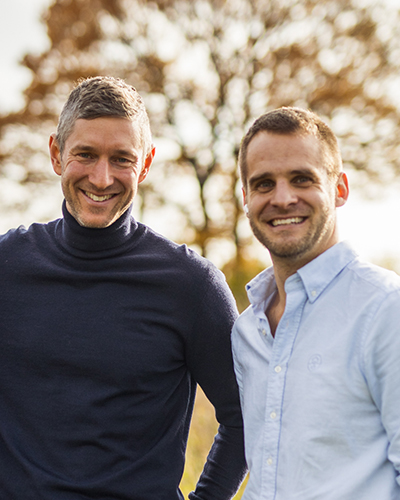 Närbild på Johan och Mikael med ett träd i bakgrunden.