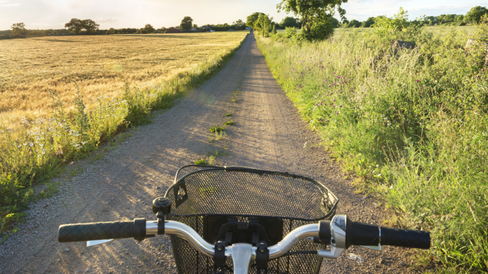 Cykelstyre vid en grusväg på landsbygden.
